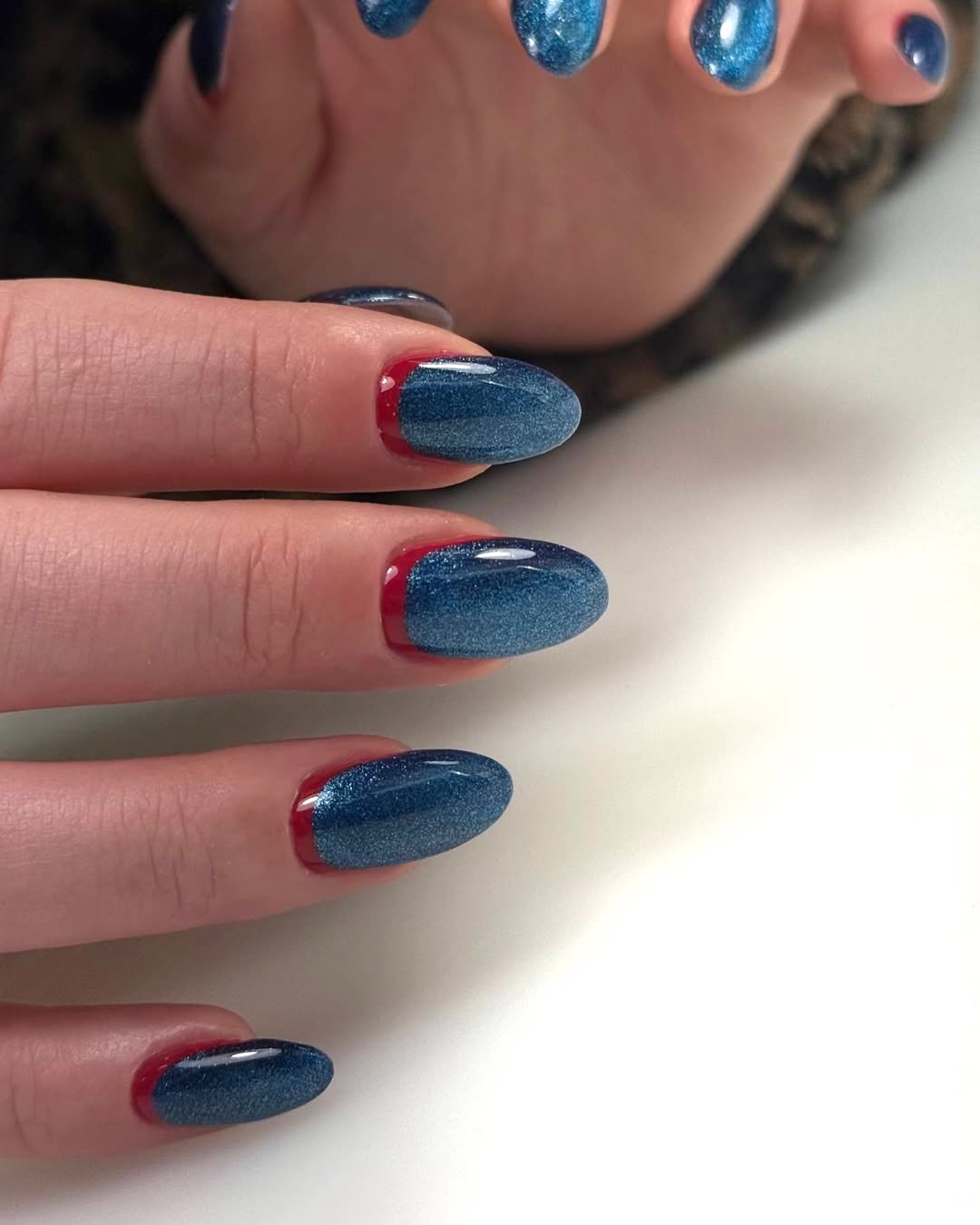 Russian manicure — blue glitter with red crescent detail